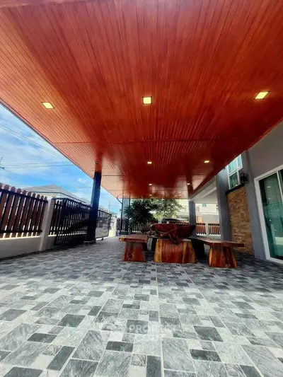 Spacious outdoor patio with wooden ceiling and stylish stone flooring