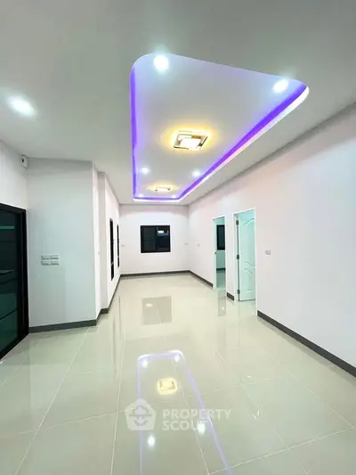 Modern interior with sleek lighting and glossy tiled floors, showcasing contemporary design.