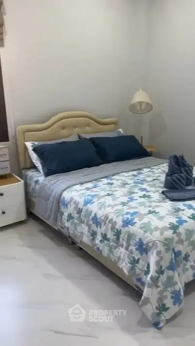 Cozy bedroom with stylish decor and comfortable bedding in modern real estate listing.