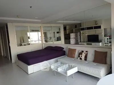 Modern studio apartment with mirrored walls and stylish furniture