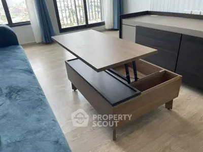Modern living room with multifunctional coffee table and panoramic city view.