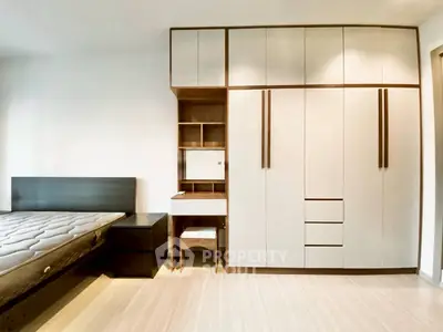 Spacious bedroom with modern built-in wardrobe and cozy bed setup