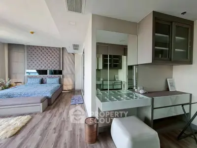 Luxurious bedroom with elegant decor and modern furnishings, featuring a stylish vanity area and plush bedding.