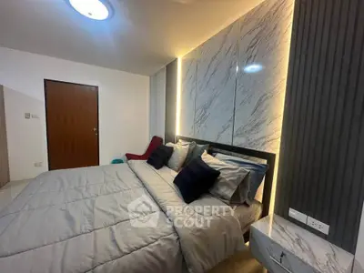 Luxurious bedroom with modern design and ambient lighting, featuring a comfortable bed and stylish decor.