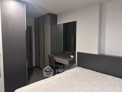 Modern bedroom with sleek furniture and built-in wardrobe