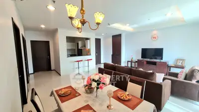 Spacious open-plan living and dining area with modern decor and elegant lighting.