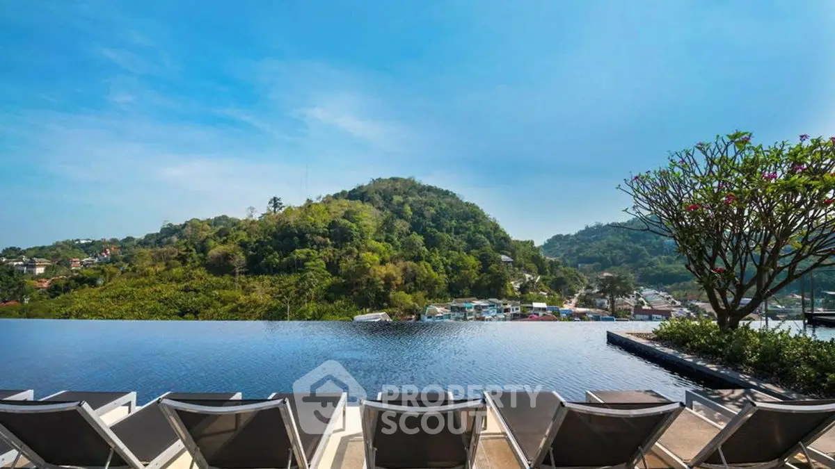 Stunning infinity pool with panoramic mountain views and luxurious sun loungers.