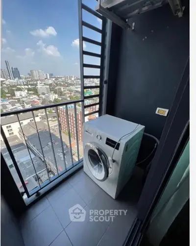 High-rise apartment balcony with city view and washing machine