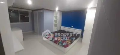 Spacious bedroom with vibrant bedding and modern design