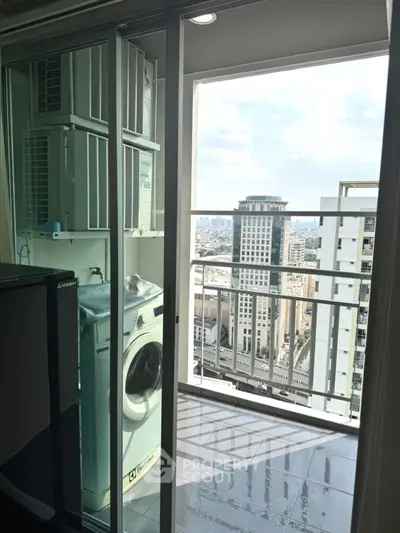 High-rise apartment balcony with city view and washing machine setup.