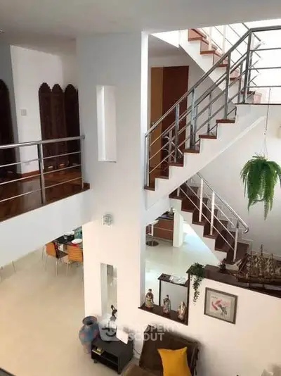 Modern multi-level home interior with stylish staircase and open living area