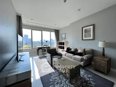 Spacious living room with modern furniture and large window offering city views.