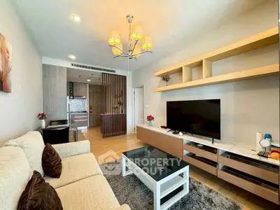 Modern living room with stylish decor and open kitchen layout in a contemporary apartment.