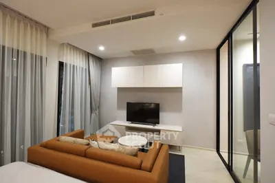 Modern living room with sleek furniture and large windows in a stylish apartment.