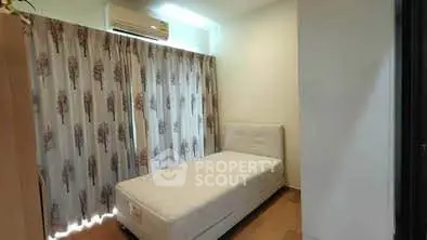 Cozy bedroom with single bed and floral curtains, perfect for a peaceful retreat.