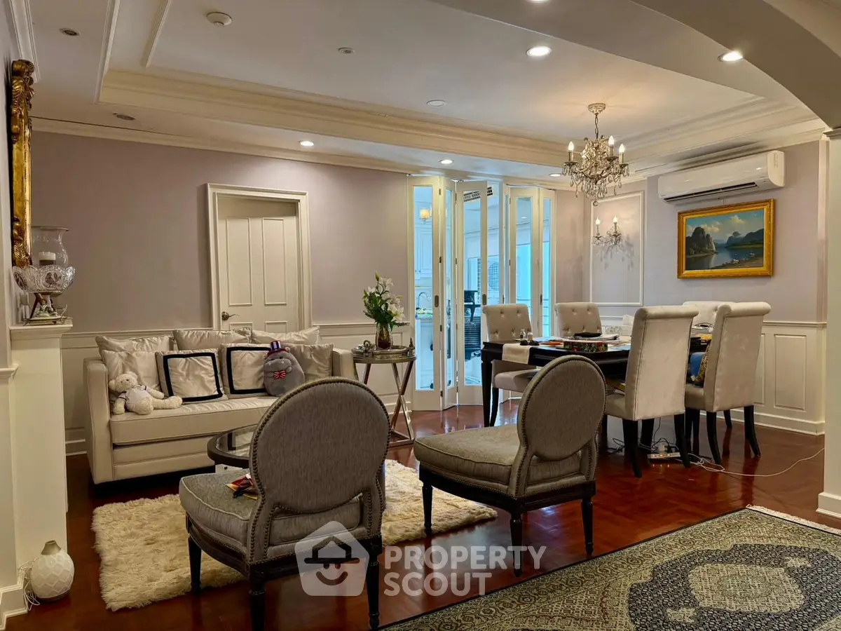 Elegant living and dining area with classic decor and chandelier lighting