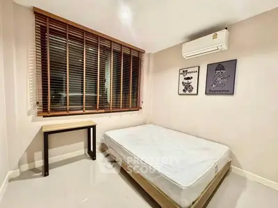 Modern minimalist bedroom with large window and air conditioning