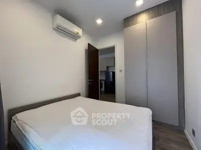 Cozy bedroom with modern air conditioning and sleek wardrobe design.