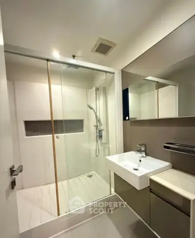 Modern bathroom with glass shower and sleek fixtures