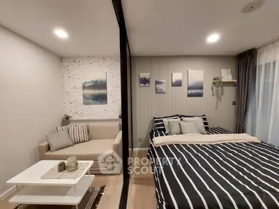 Modern studio apartment with cozy living area and stylish bedroom decor.