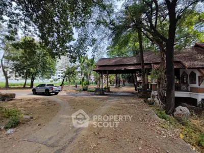 Charming rustic property with lush greenery and spacious driveway