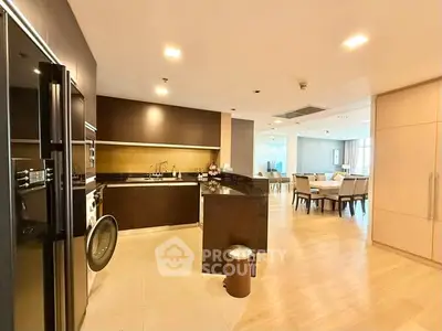 Spacious open-layout kitchen and dining area with modern appliances and elegant design.