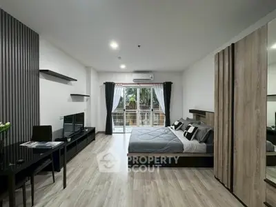 Modern studio apartment with stylish decor and balcony view