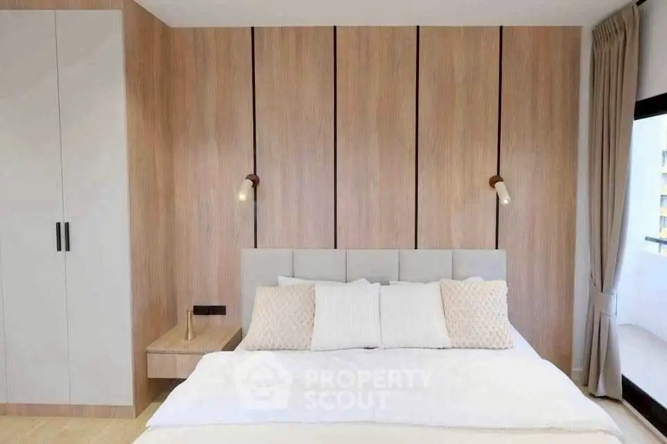 Modern bedroom with elegant wood paneling and cozy lighting