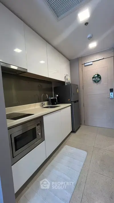 Modern kitchen with sleek white cabinets and built-in appliances