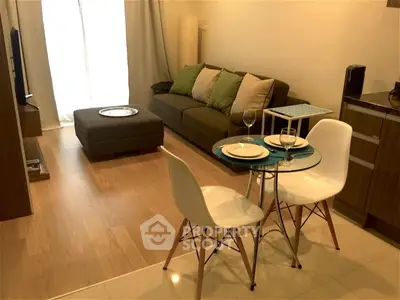 Cozy modern living room with dining area, featuring stylish furniture and warm lighting.