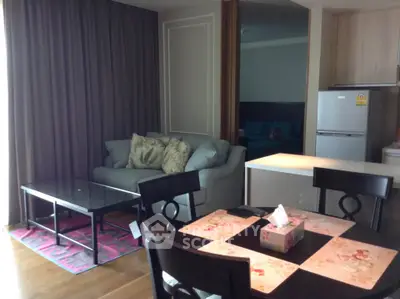 Cozy living room with modern furniture and open kitchen layout in a stylish apartment.