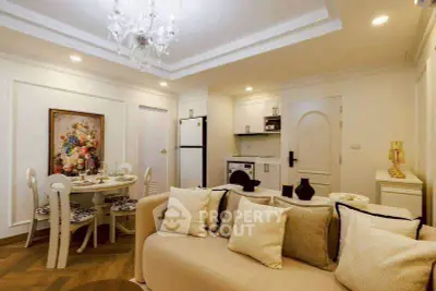 Elegant living room with cozy seating, dining area, and modern kitchen in open layout.