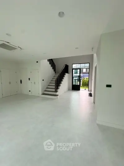 Spacious modern interior with staircase and large windows