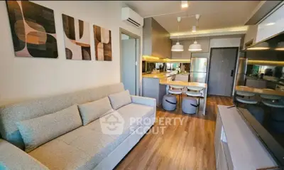 Modern living room with stylish decor and open kitchen layout in a cozy apartment.