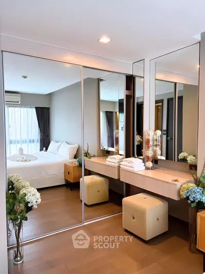 Luxurious bedroom with mirrored wardrobe and elegant decor in modern apartment