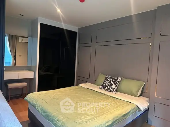 Modern bedroom with stylish decor and comfortable bedding in a contemporary apartment.