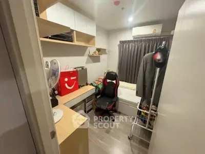 Cozy study room with modern desk, chair, and ample storage in compact apartment.