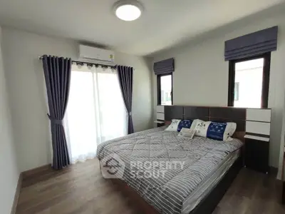 Spacious bedroom with modern decor and natural light