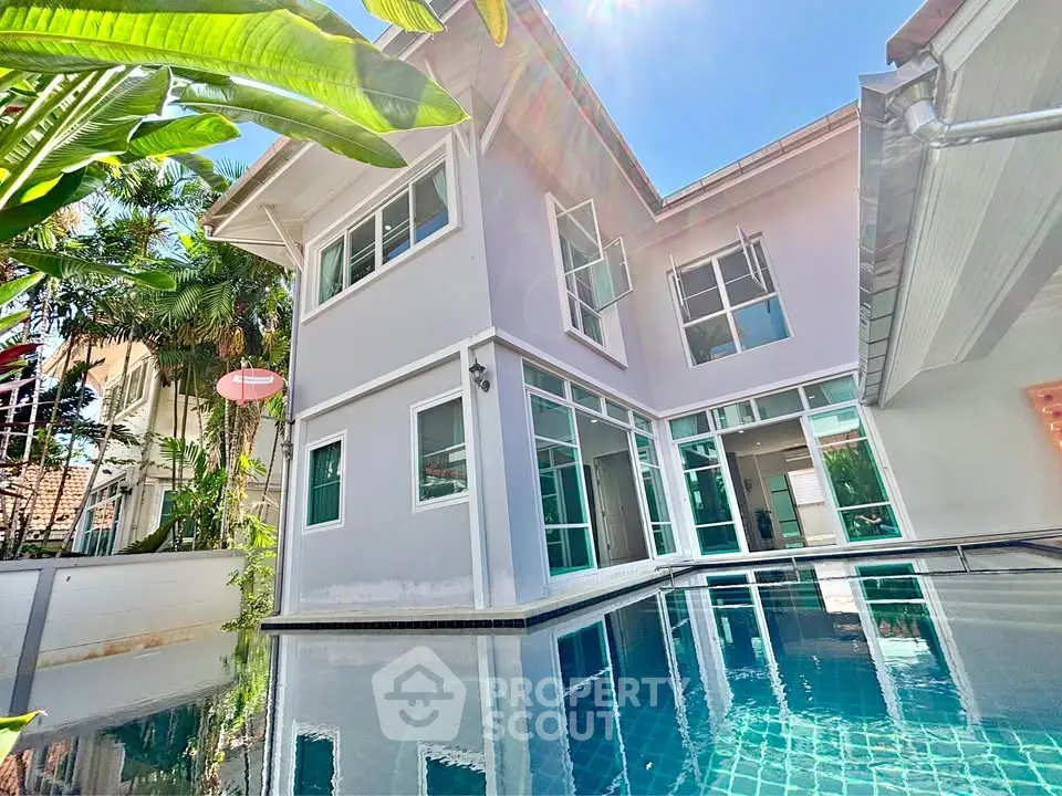 Stunning modern home with pool and lush greenery, perfect for luxury living.