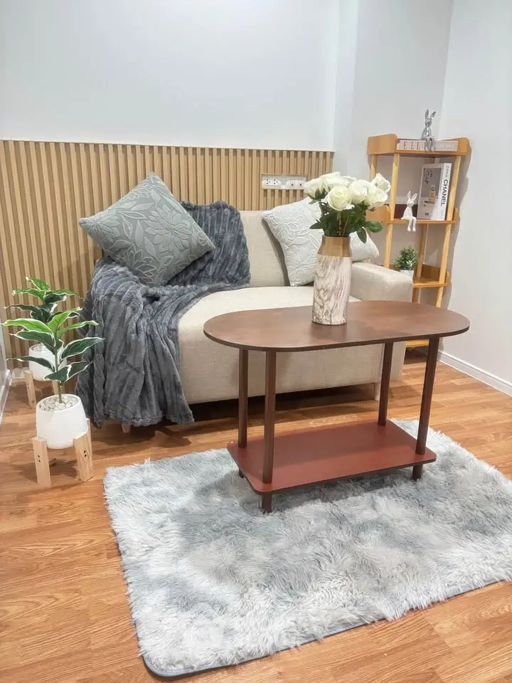 Cozy living room with stylish decor, featuring a plush sofa, elegant coffee table, and decorative plants.
