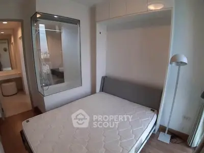 Modern bedroom with built-in storage and glass partition for stylish urban living.