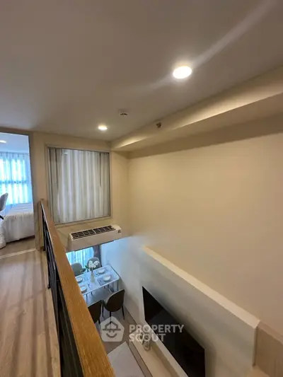 Modern loft-style apartment with open living area and dining space, featuring sleek design and ample natural light.