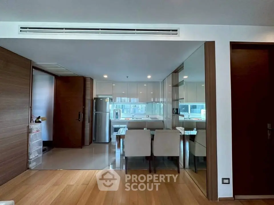 Modern kitchen with sleek design and dining area in open layout apartment