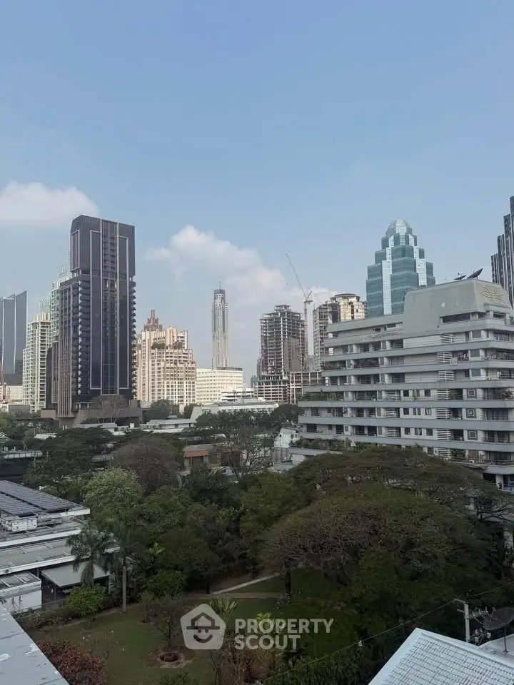 Stunning cityscape view showcasing modern skyscrapers and lush greenery, perfect for urban living enthusiasts.