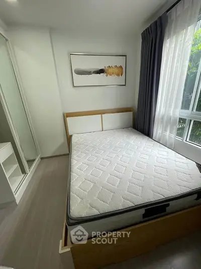 Modern bedroom with stylish decor and natural light, featuring a comfortable bed and sleek wardrobe.