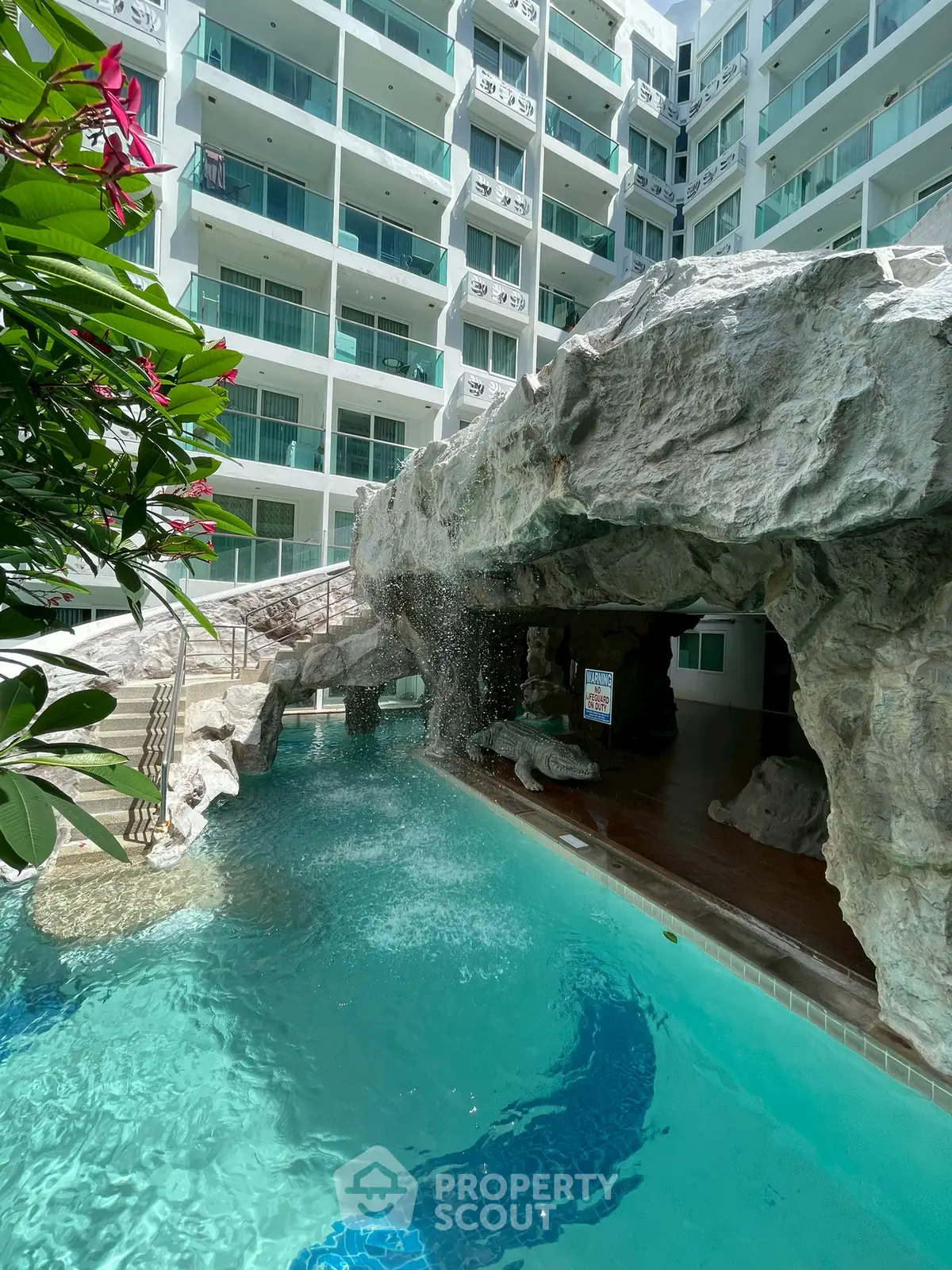 Luxurious condo with unique pool and waterfall feature, perfect for relaxation and leisure.