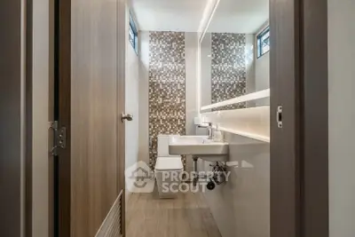 Modern bathroom with stylish tile accent wall and sleek fixtures