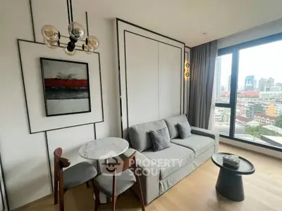 Modern living room with city view, stylish decor, and cozy seating area in a high-rise apartment.
