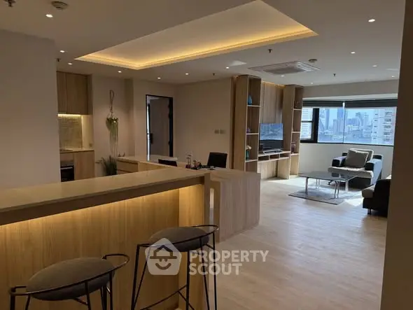 Modern open-plan living room with stylish furniture and city view.