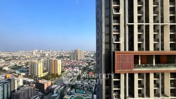 Stunning cityscape view from high-rise building balcony with modern architectural design.